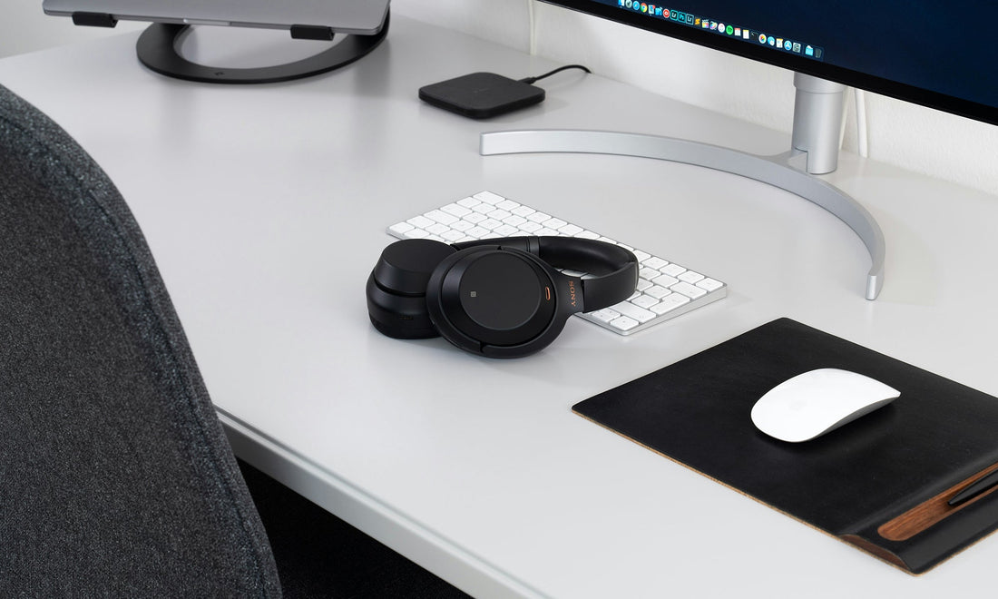Minimal workspace with leather mousepad pad, notebook, and refined tools by HappyPatina
