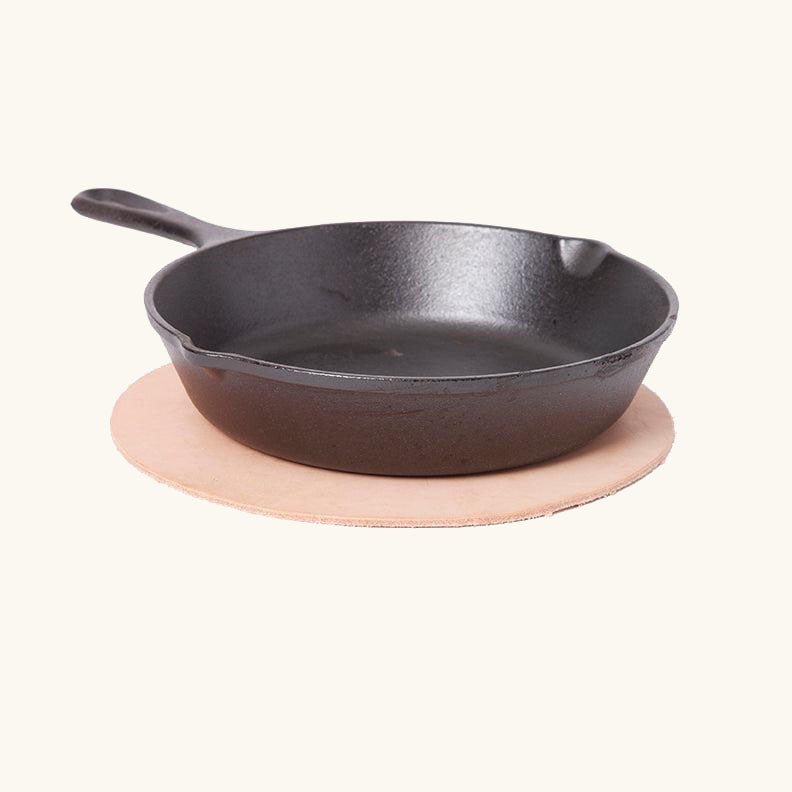 Round leather trivet in natural veg‑tan by Happy Patina