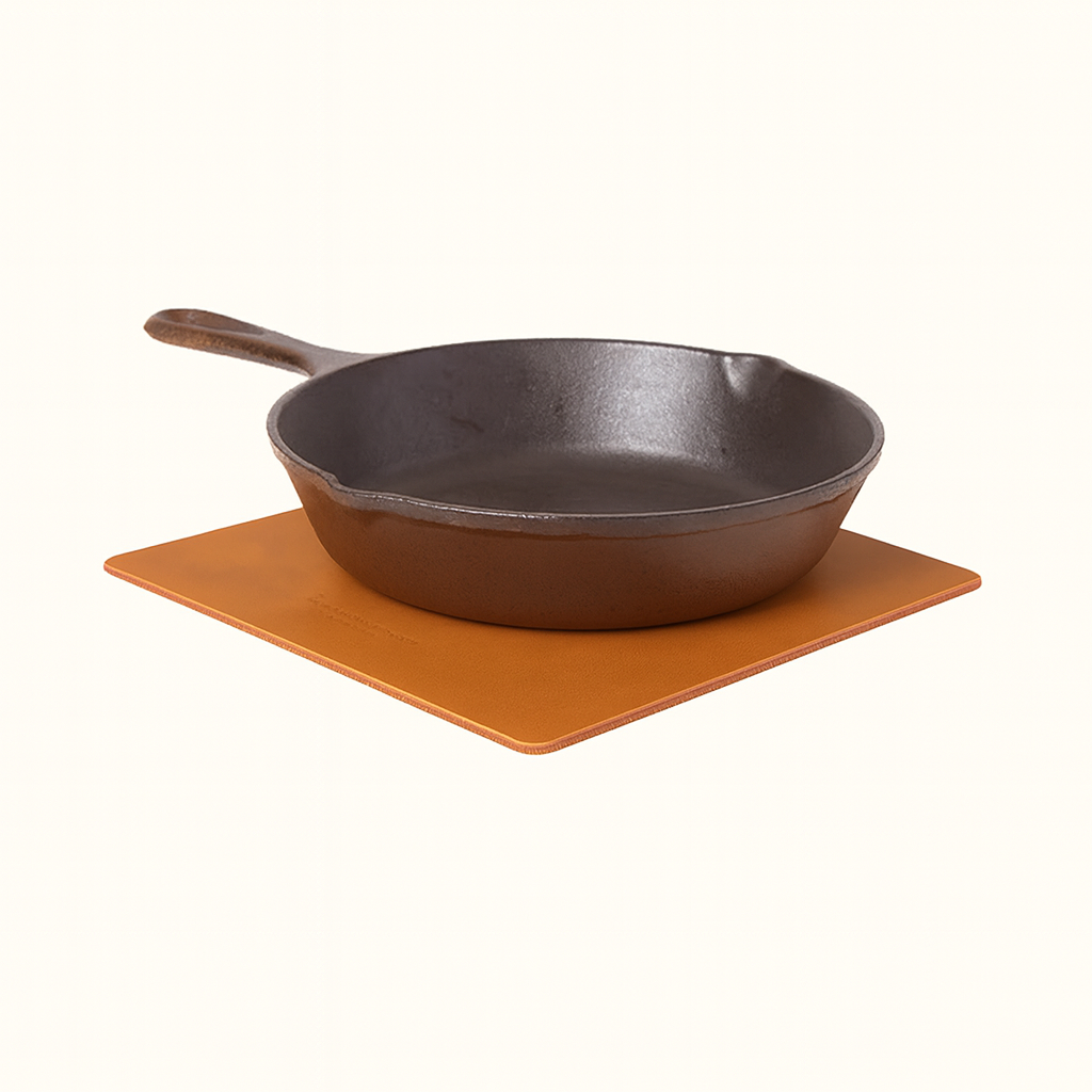 Handcrafted square vegetable‑tanned tan leather trivet by Happy Patina