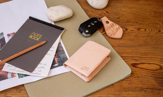 Leather everyday carry essentials organized on a desk with warm light by HappyPatina