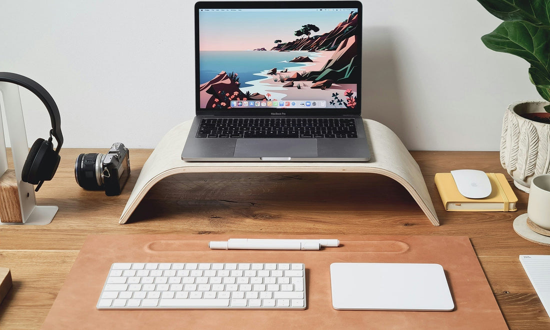 Leather desk pad on wooden surface with ceramic cup and warm light by HappyPatina
