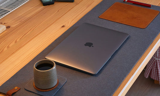 Minimal desk setup with leather desk mat, MacBook, and wooden accessories by HappyPatina
