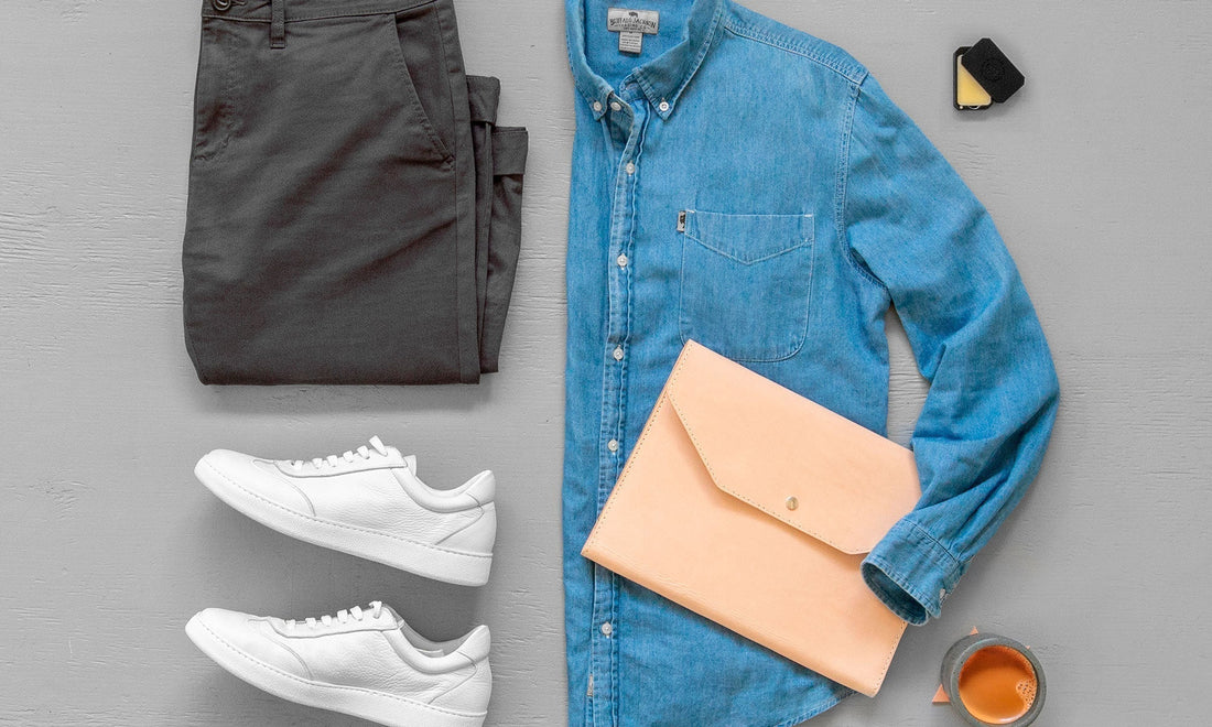 Leather travel essentials including folio, wallet, and key fob on linen background by HappyPatina