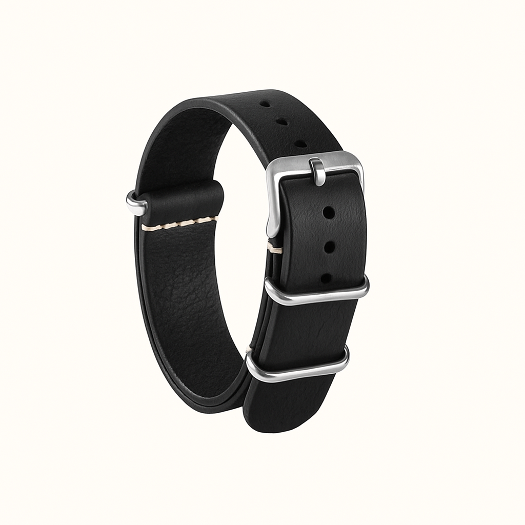 Handcrafted NATO-style watch strap in natural veg-tan black leather (20mm). Durable, elegant, and ages beautifully with patina. Made in Spain.