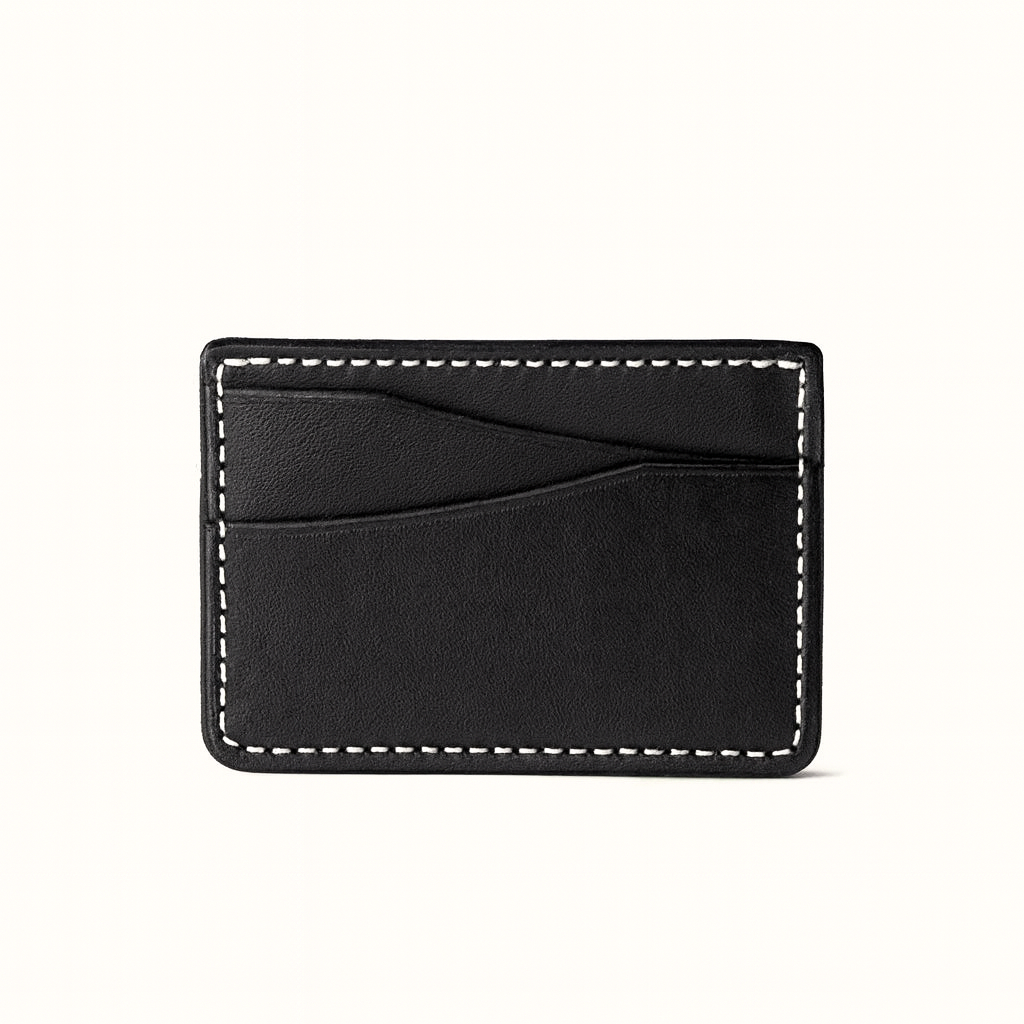 Slim card wallet in natural vegetable‑tanned black leather by Happy Patina